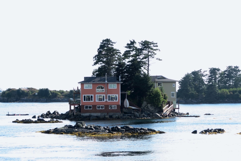 a house on a small island in the middle of a lake