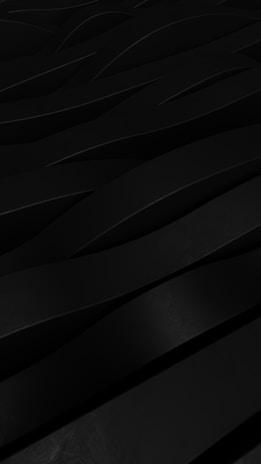 Sleek black surface with delicate pink glowing geometric patterns and smooth gradient effects.