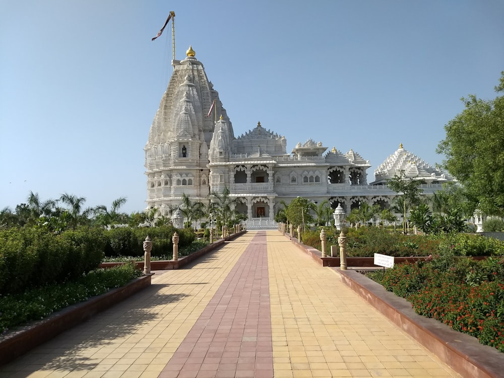 a large white building with a long walkway leading to it