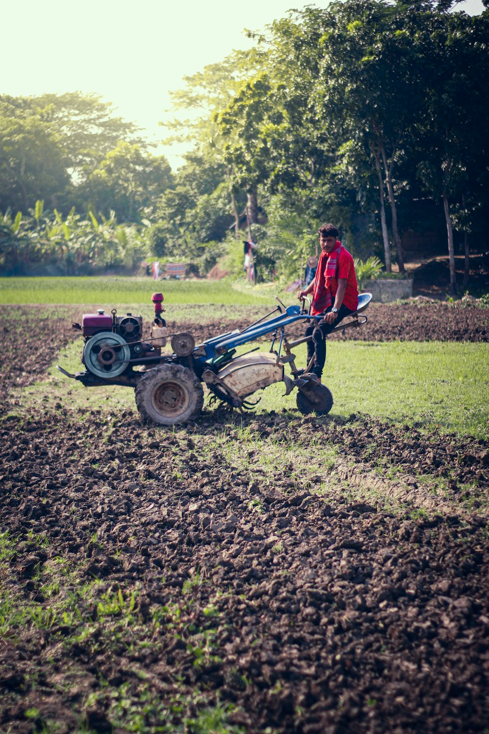 a man is plowing a field with a tractor