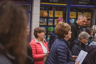 a group of people standing in front of a store