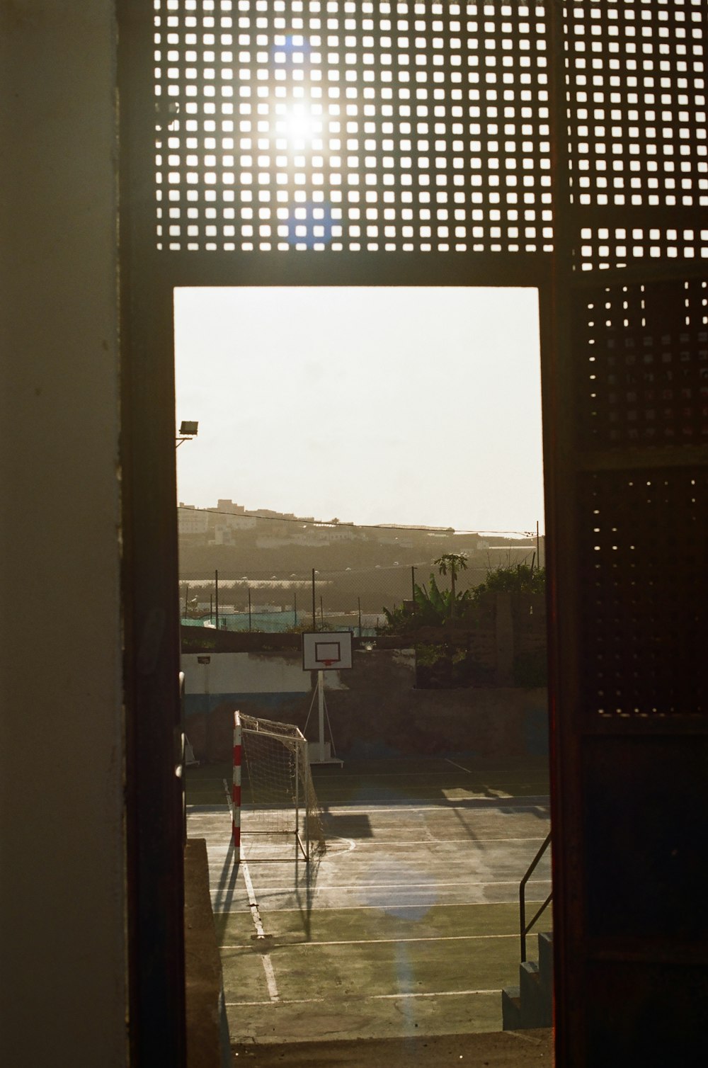 an open door leading to a basketball court