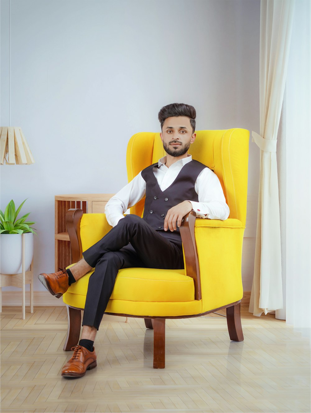 a man sitting in a yellow chair in a room