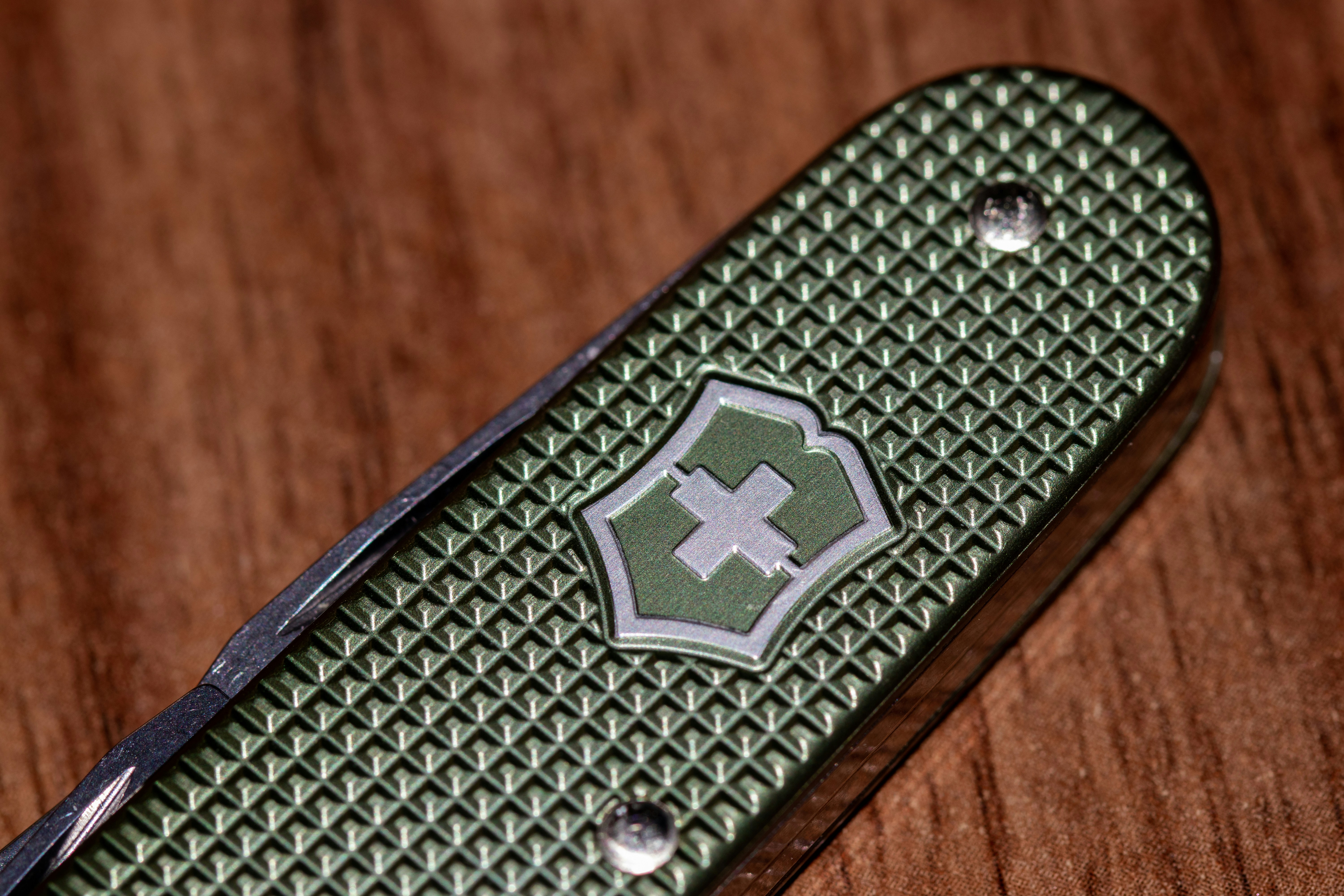 a close up of a knife on a wooden table