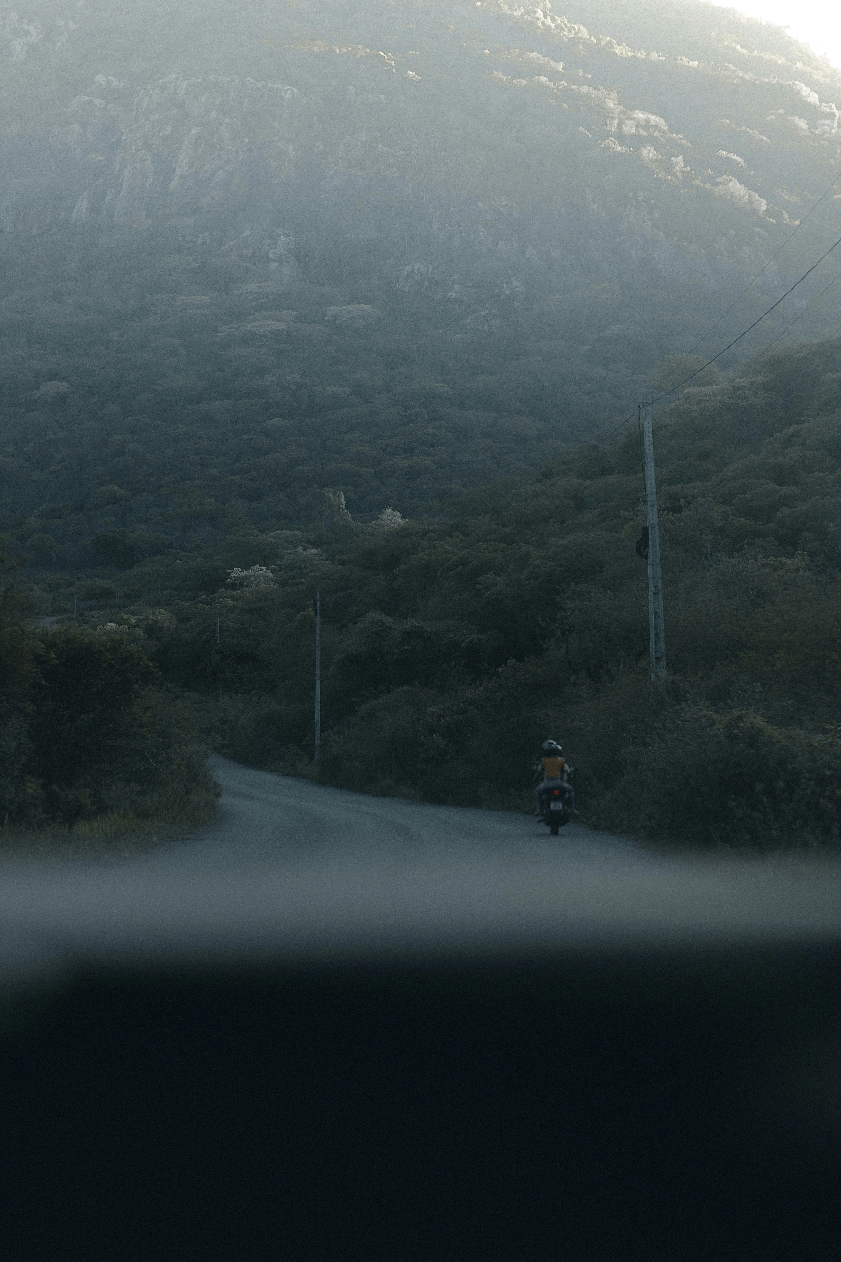 a person riding a motorcycle down a road