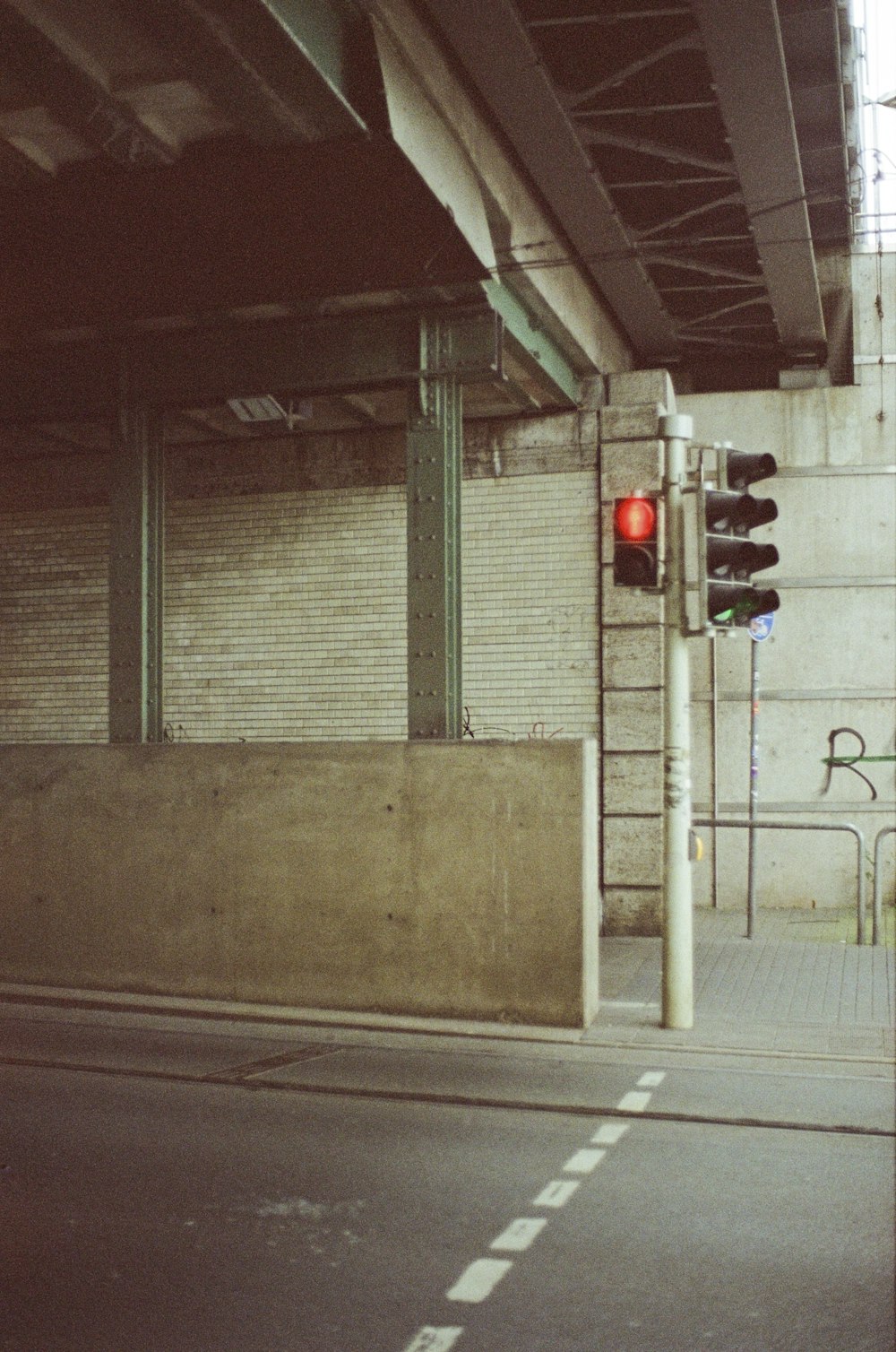a red traffic light sitting on the side of a road