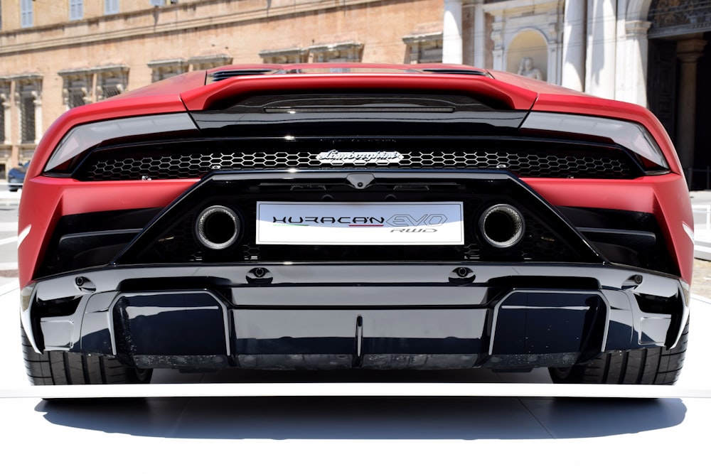 a red sports car parked in front of a building