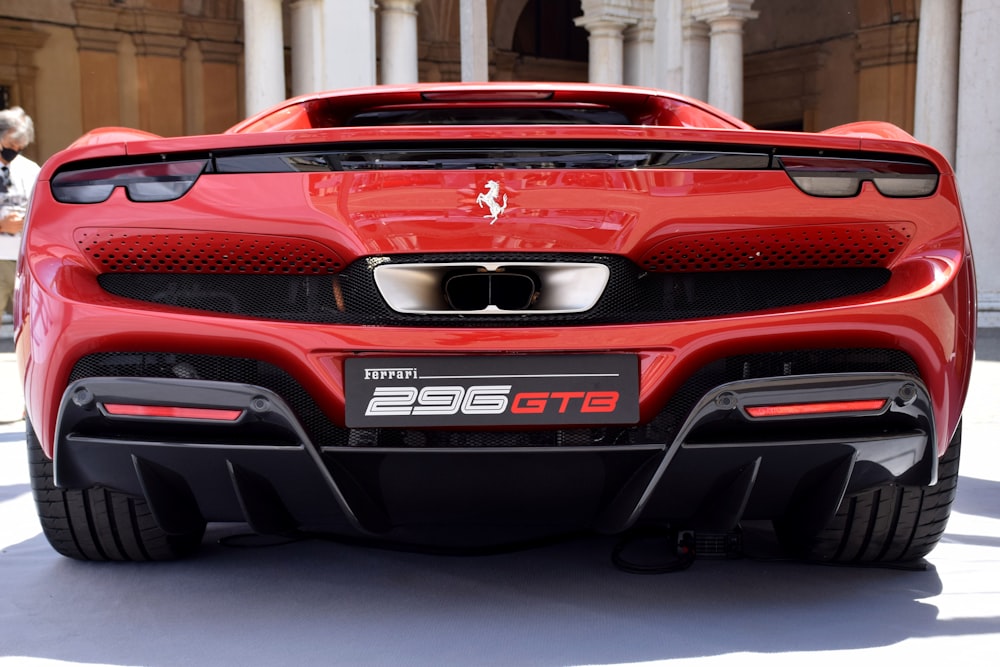 a red sports car parked in front of a building