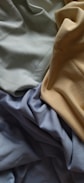 a close up of a bed with sheets and sheets