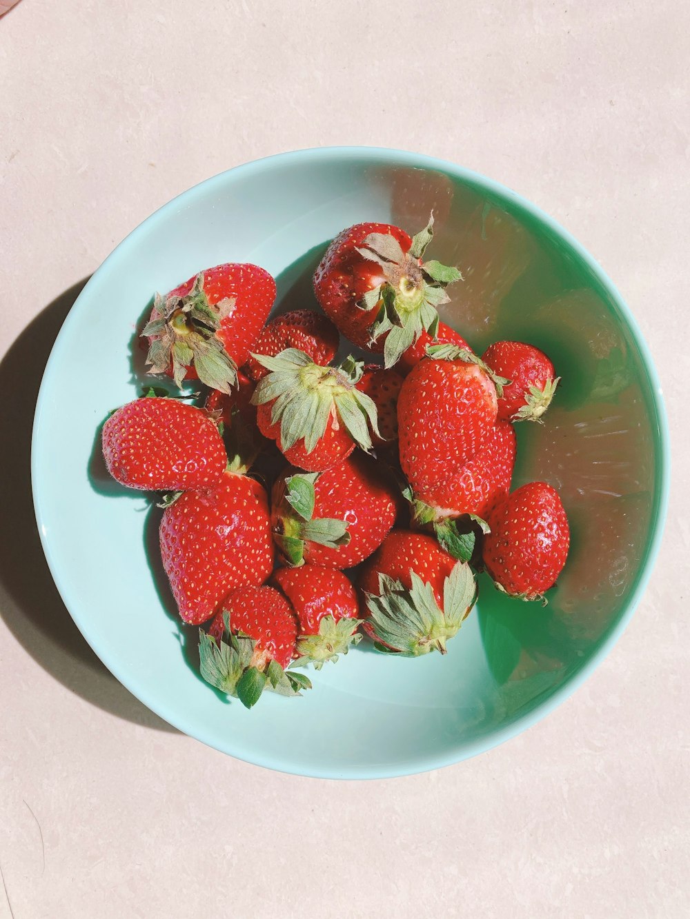a bowl of strawberries on a table