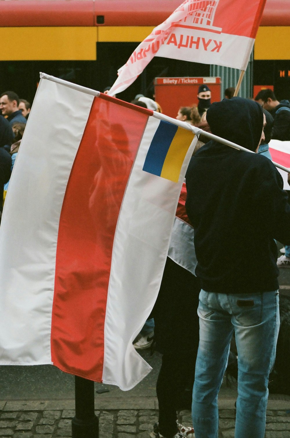 a man holding a flag in front of a train