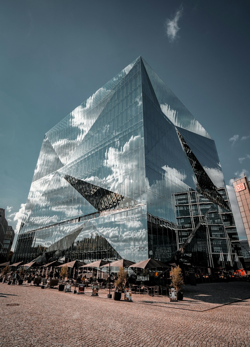 a large glass building with a sky background