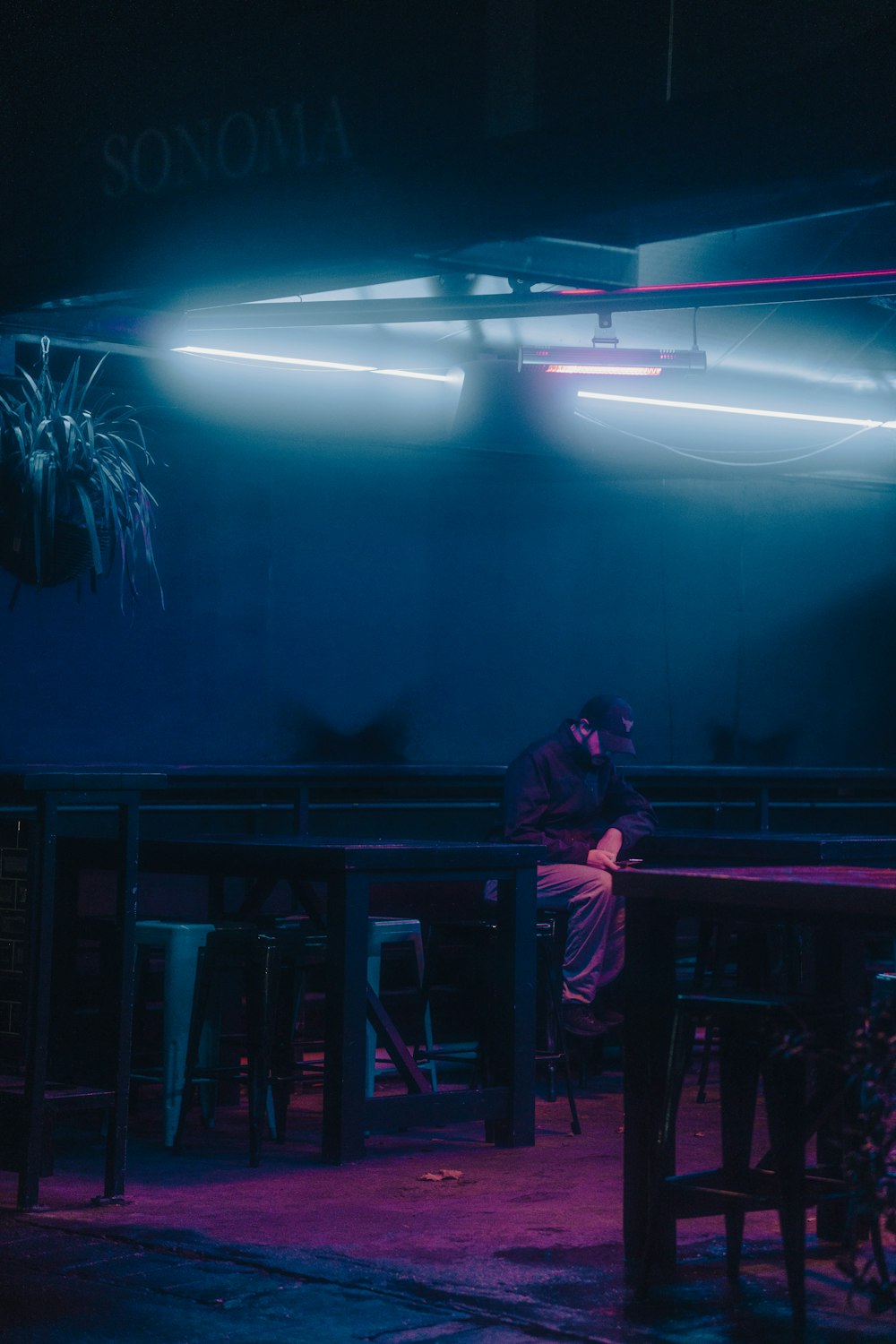 a person sitting at a table in a dark room