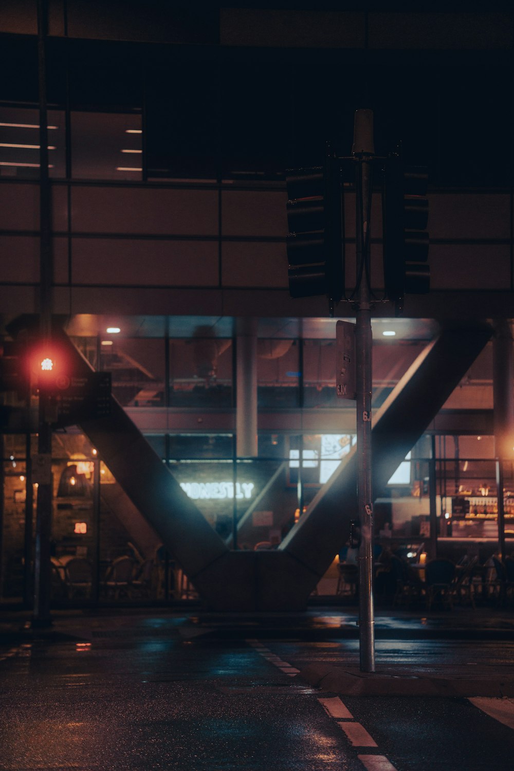 a traffic light in front of a building at night