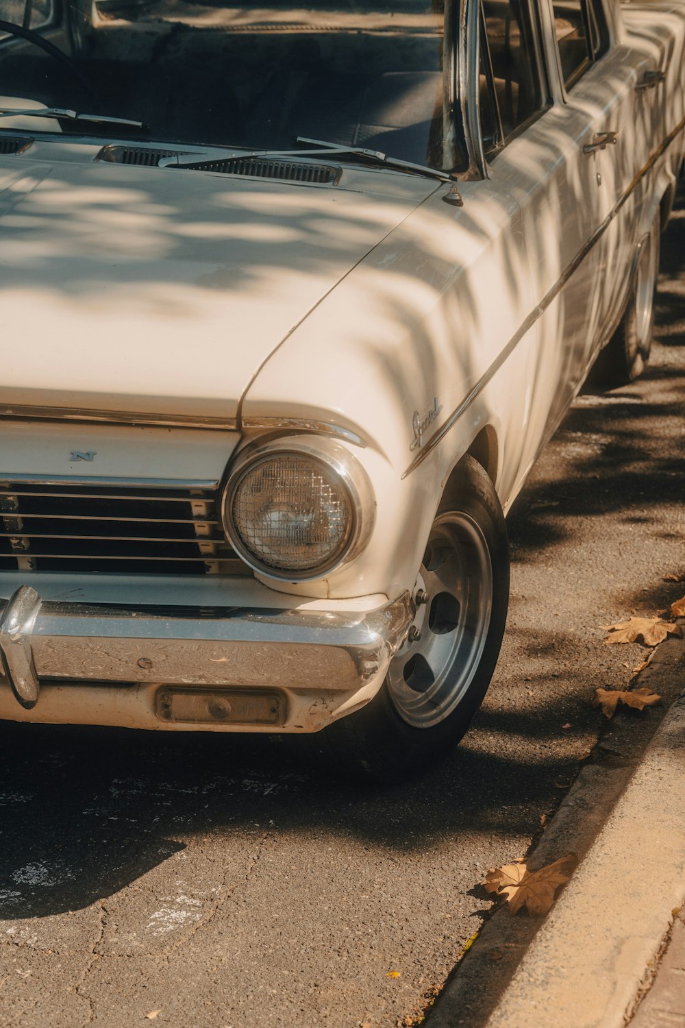 a white car parked on the side of the road