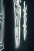 A close-up of a neon artwork glowing against a wall.