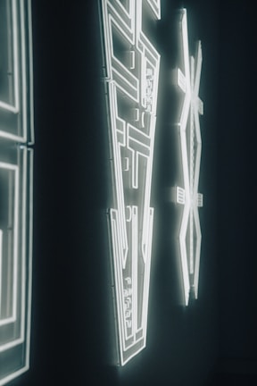 A close-up of a neon artwork glowing against a wall.