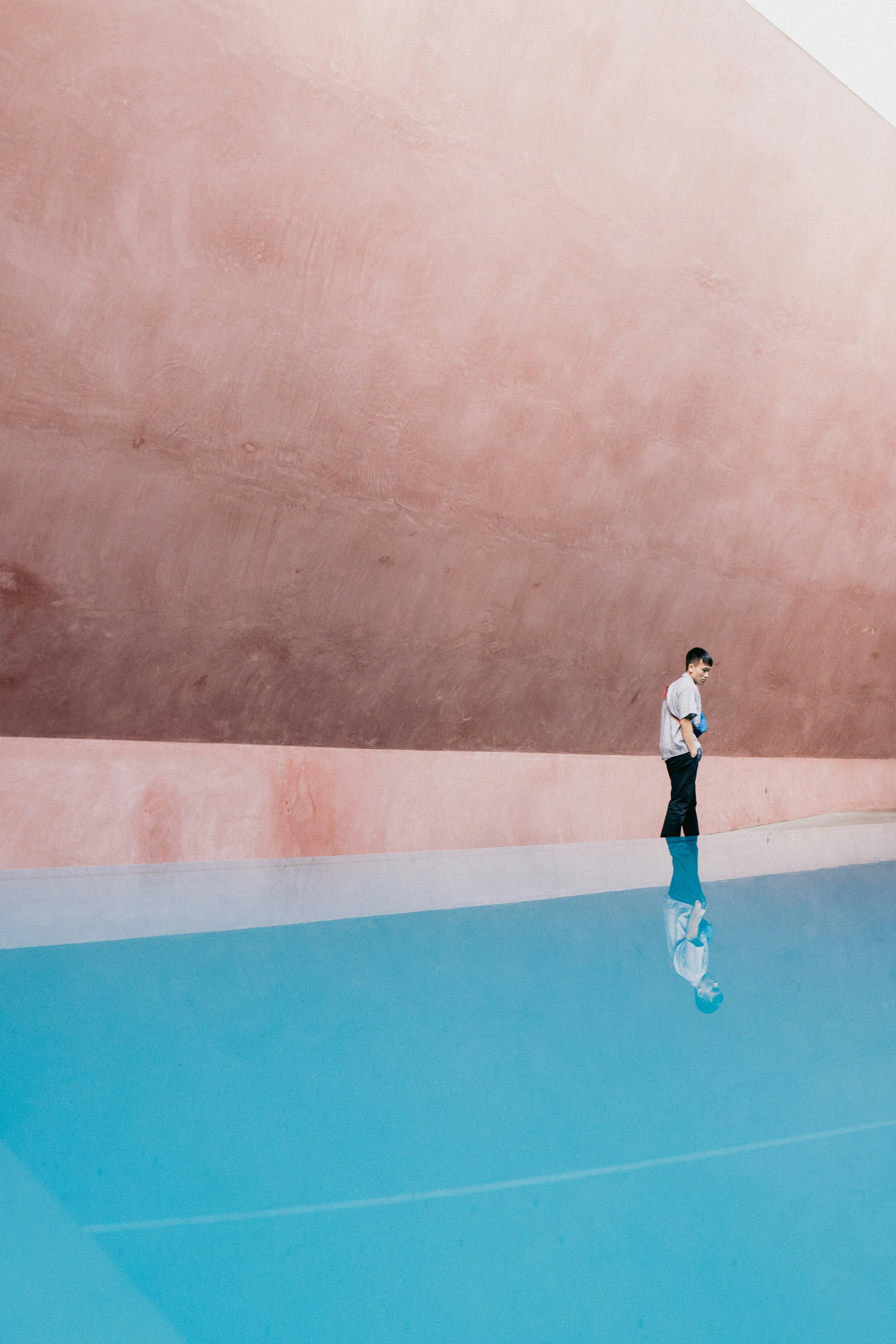 a man standing on a tennis court holding a tennis racquet