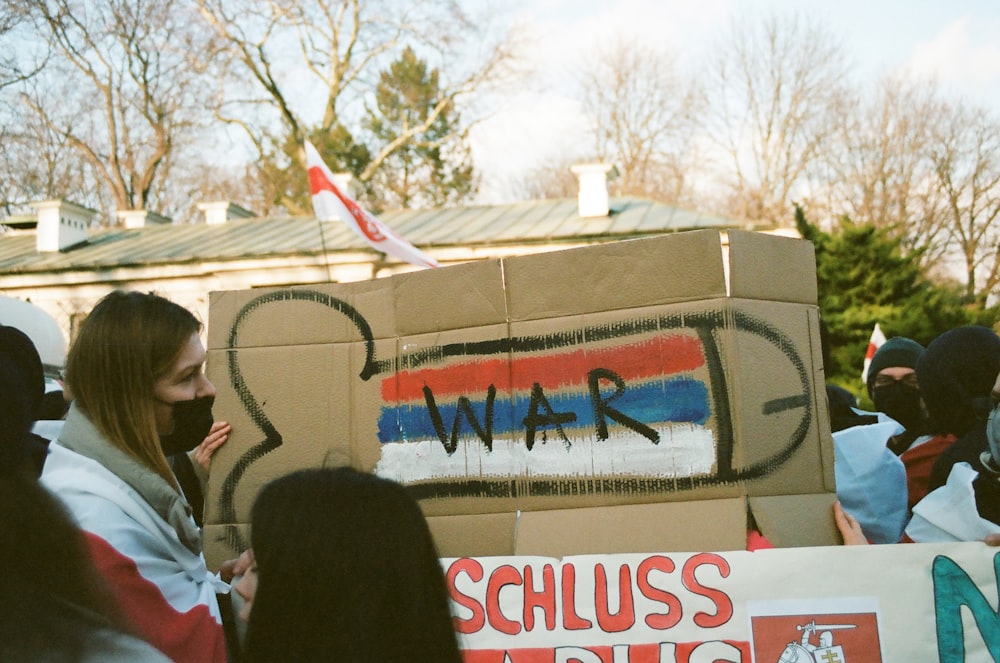 a group of people standing around a cardboard box