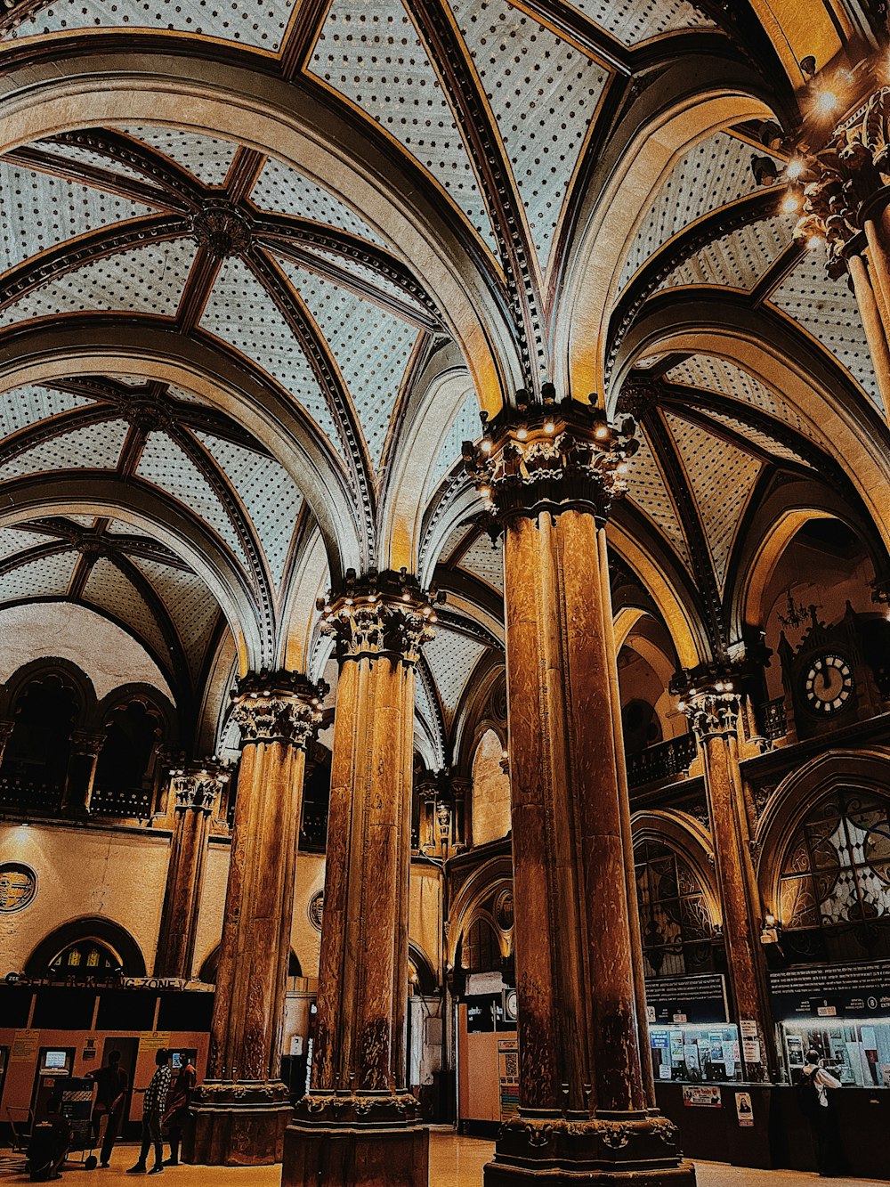 the ceiling of a large building has intricate designs on it