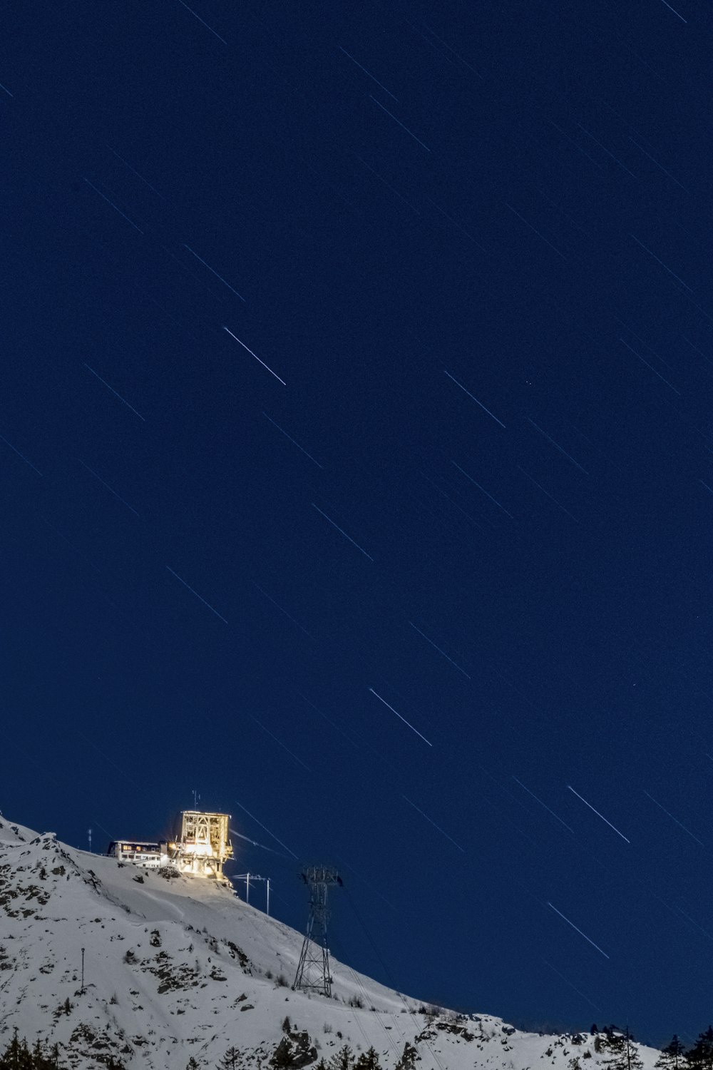 a hill with a house on top of it at night