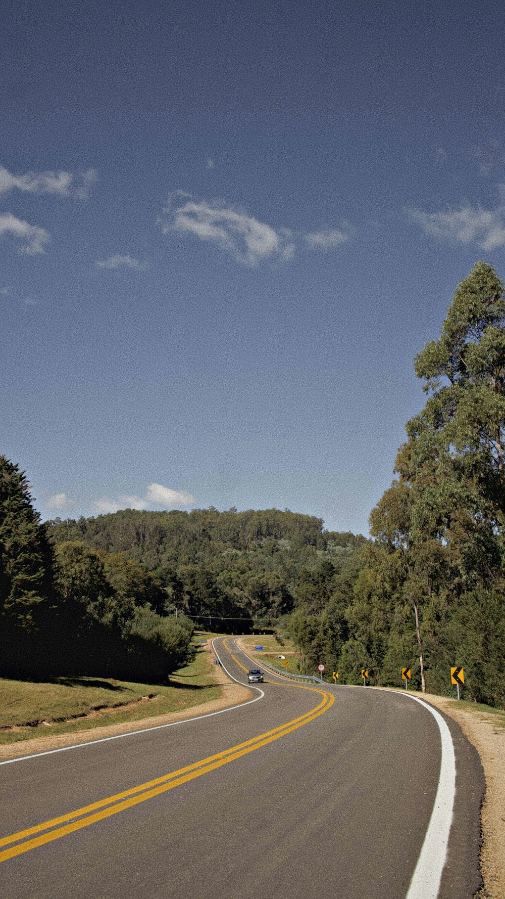 a road with a yellow line on the side of it