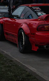 a red sports car parked on the side of the road