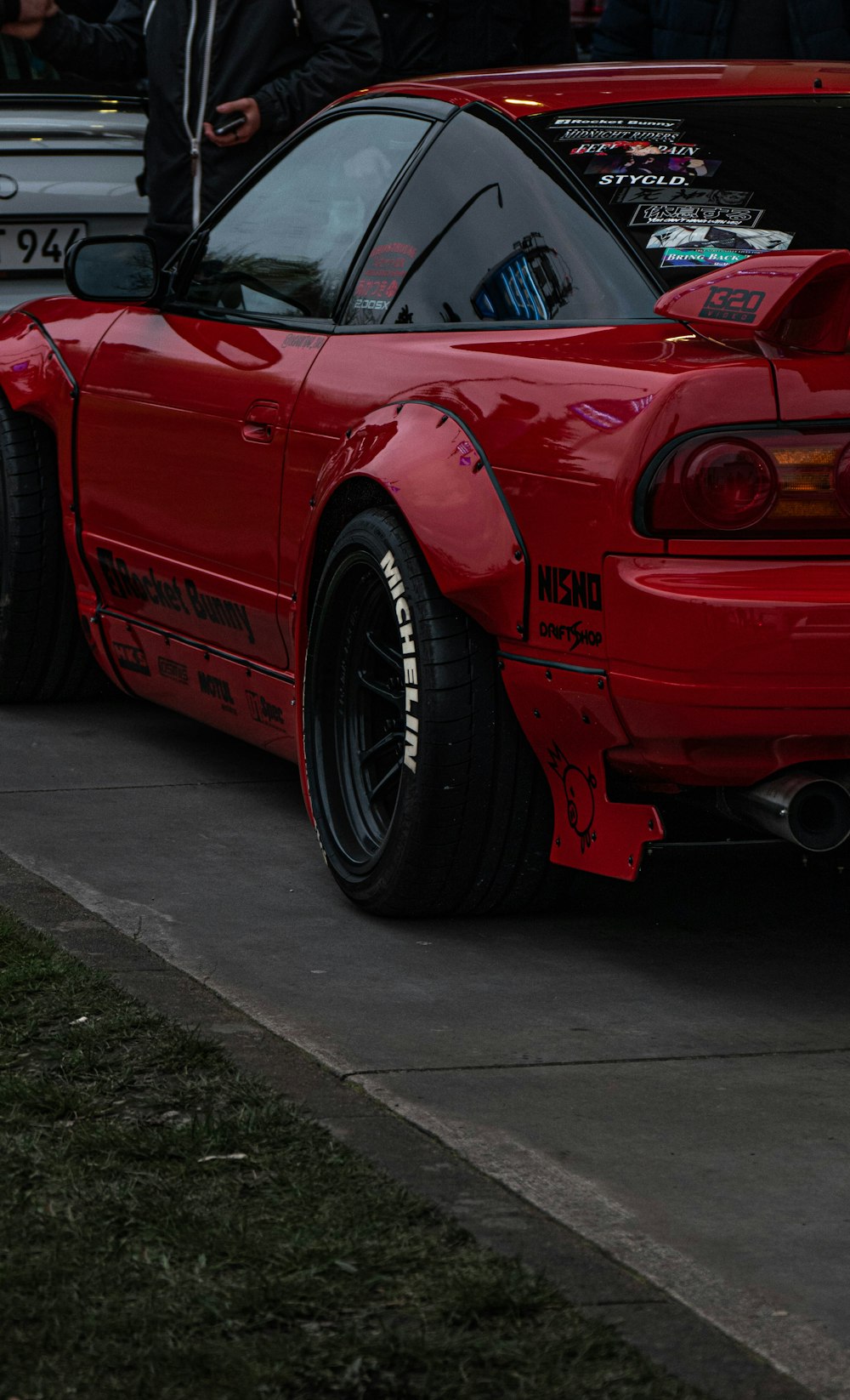 a red sports car parked on the side of the road