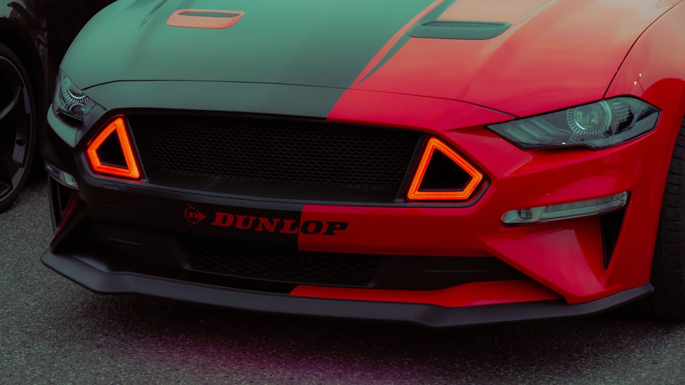 a close up of a red and green sports car