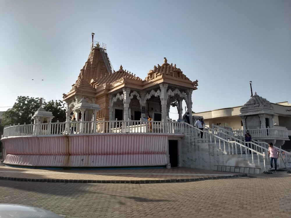 a white and pink building with a staircase leading up to it