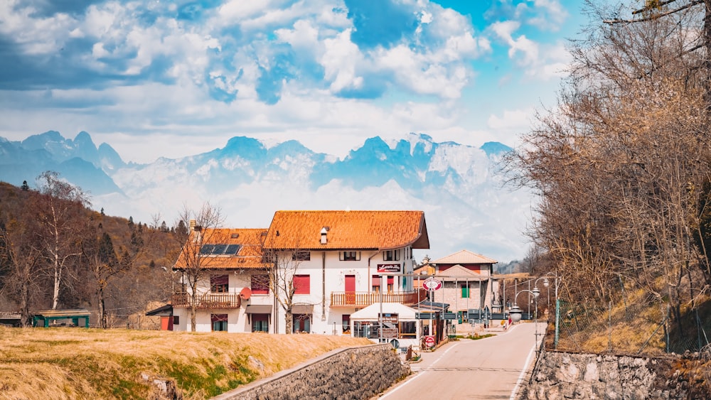 a white house with mountains in the background