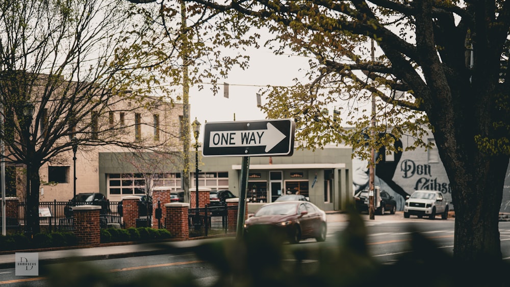 a one way street sign in front of a building