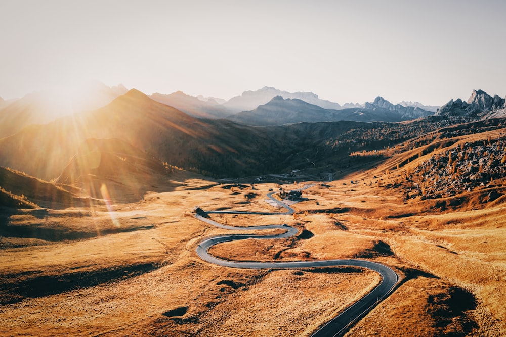 a winding road in the middle of a mountain range