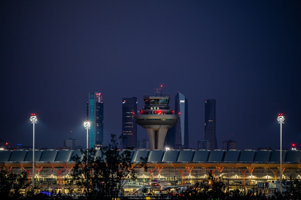 a night view of a city skyline with a tower in the middle