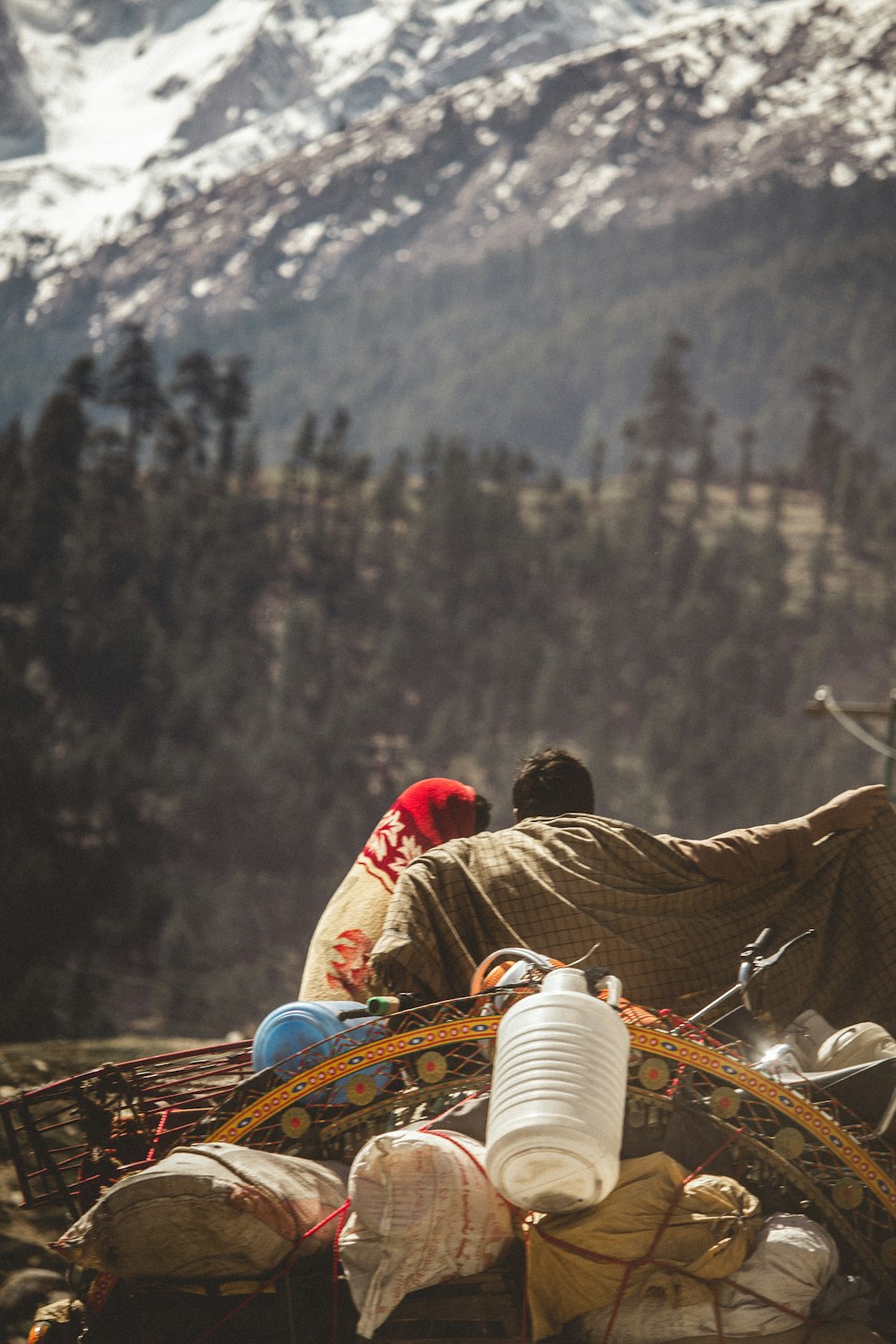 a group of people sitting on top of a mountain