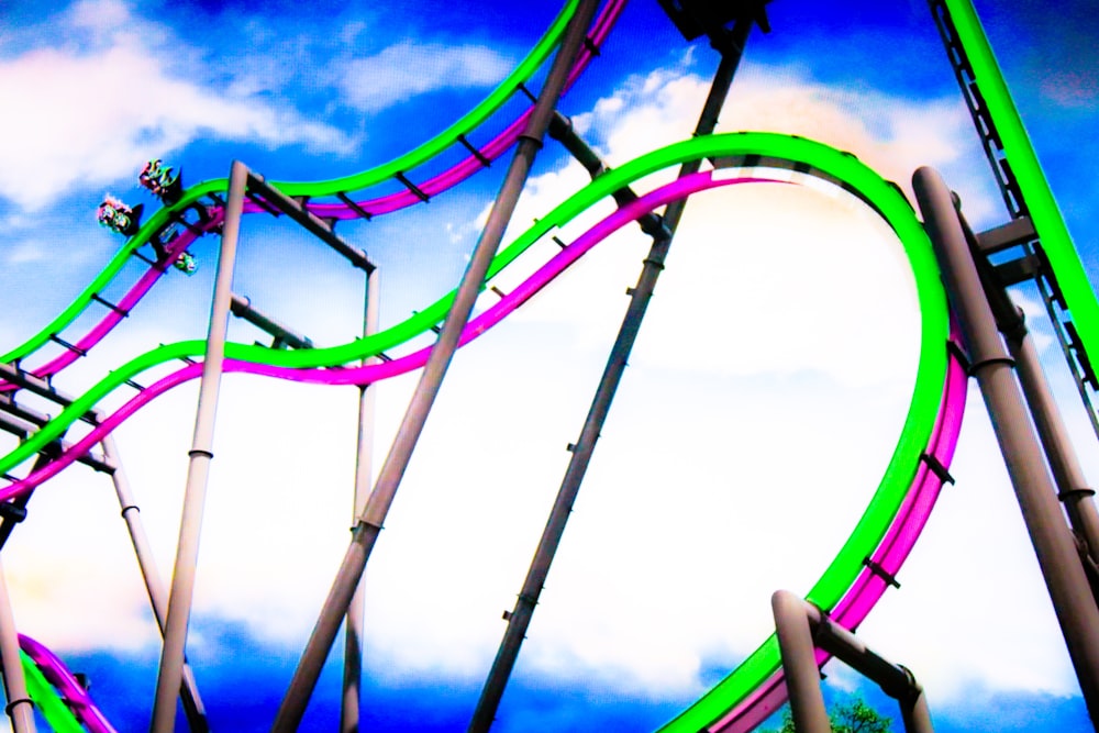 a roller coaster in the middle of a cloudy sky