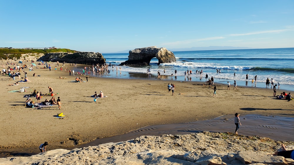 many people are on the beach near the water