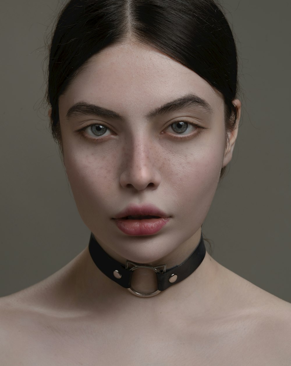 a woman with a choker around her neck