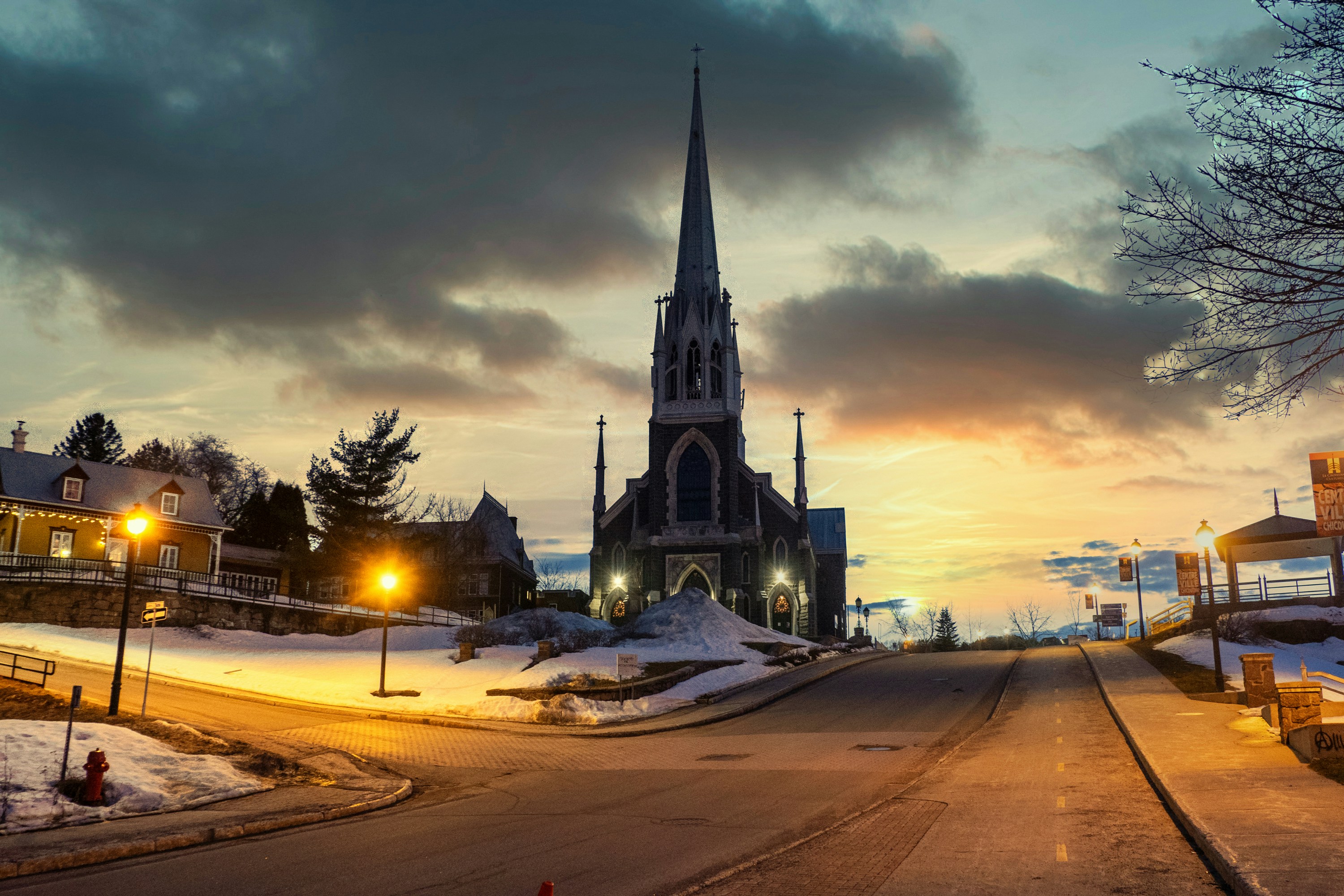 a church with a steeple lit up at night