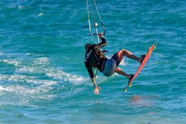 a man riding a kiteboard on top of a body of water
