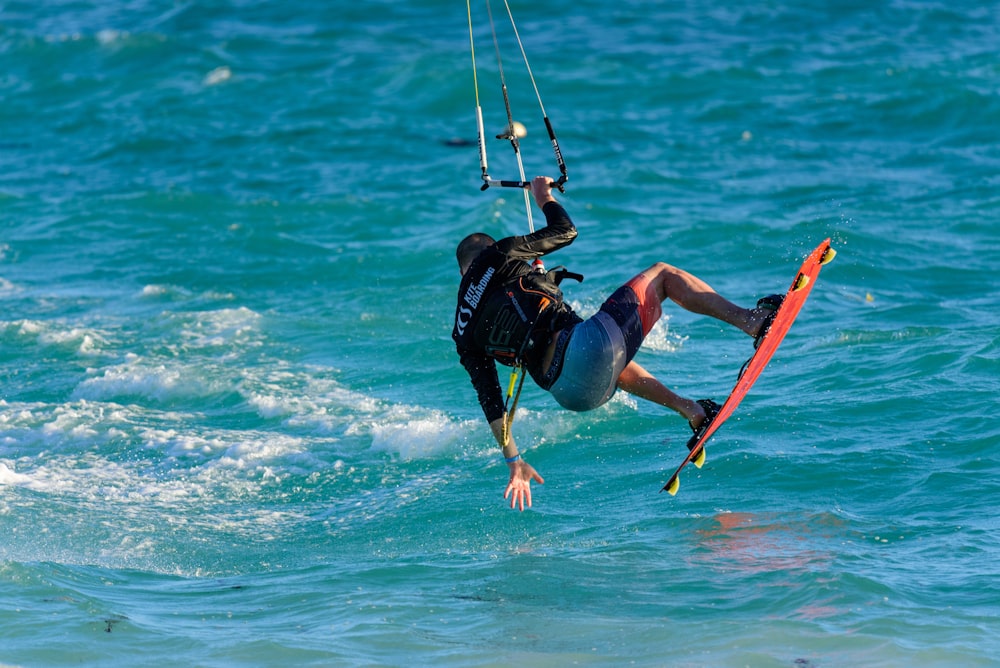 a man riding a kiteboard on top of a body of water