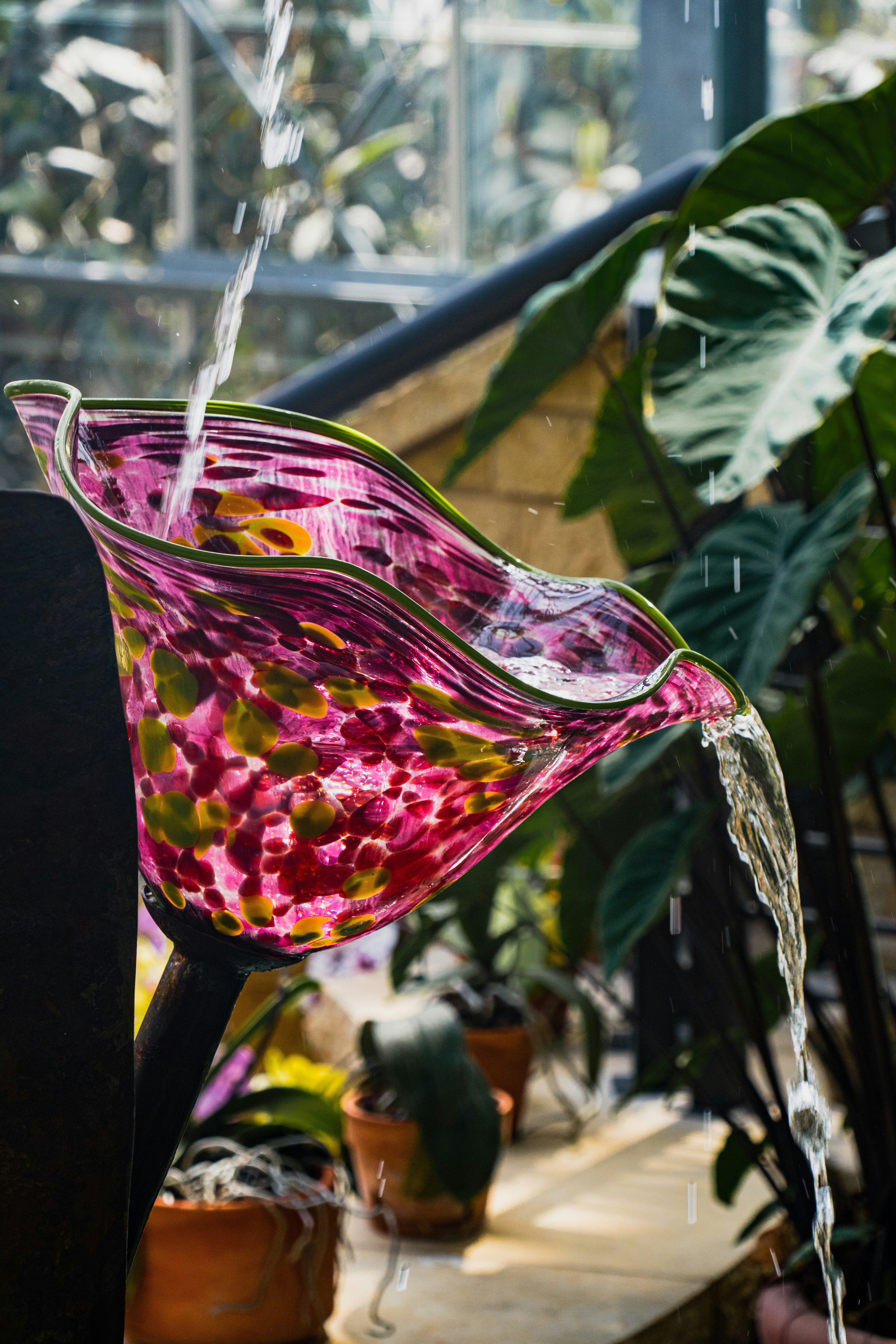a glass vase with water pouring out of it