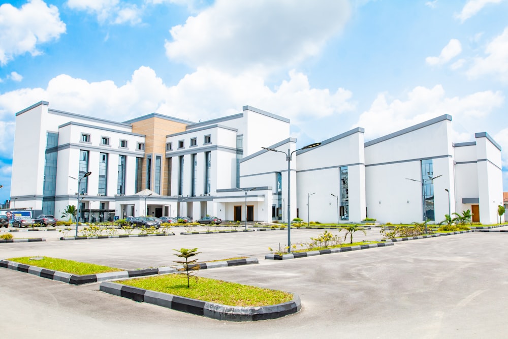 a large white building with a lot of grass in front of it