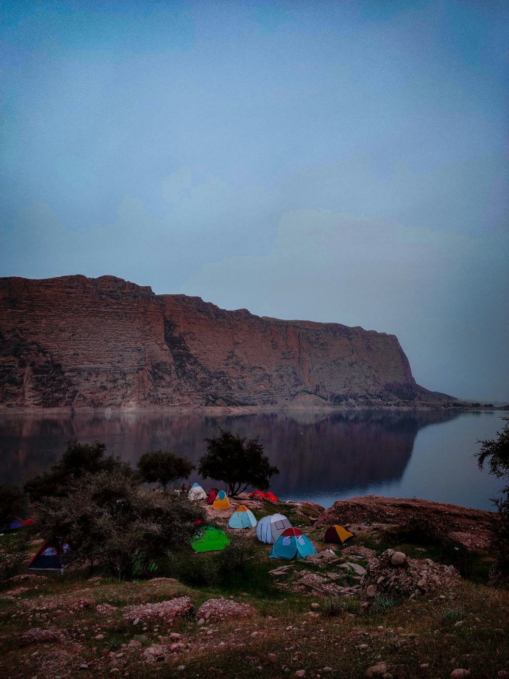 a group of tents sitting on top of a lush green hillside