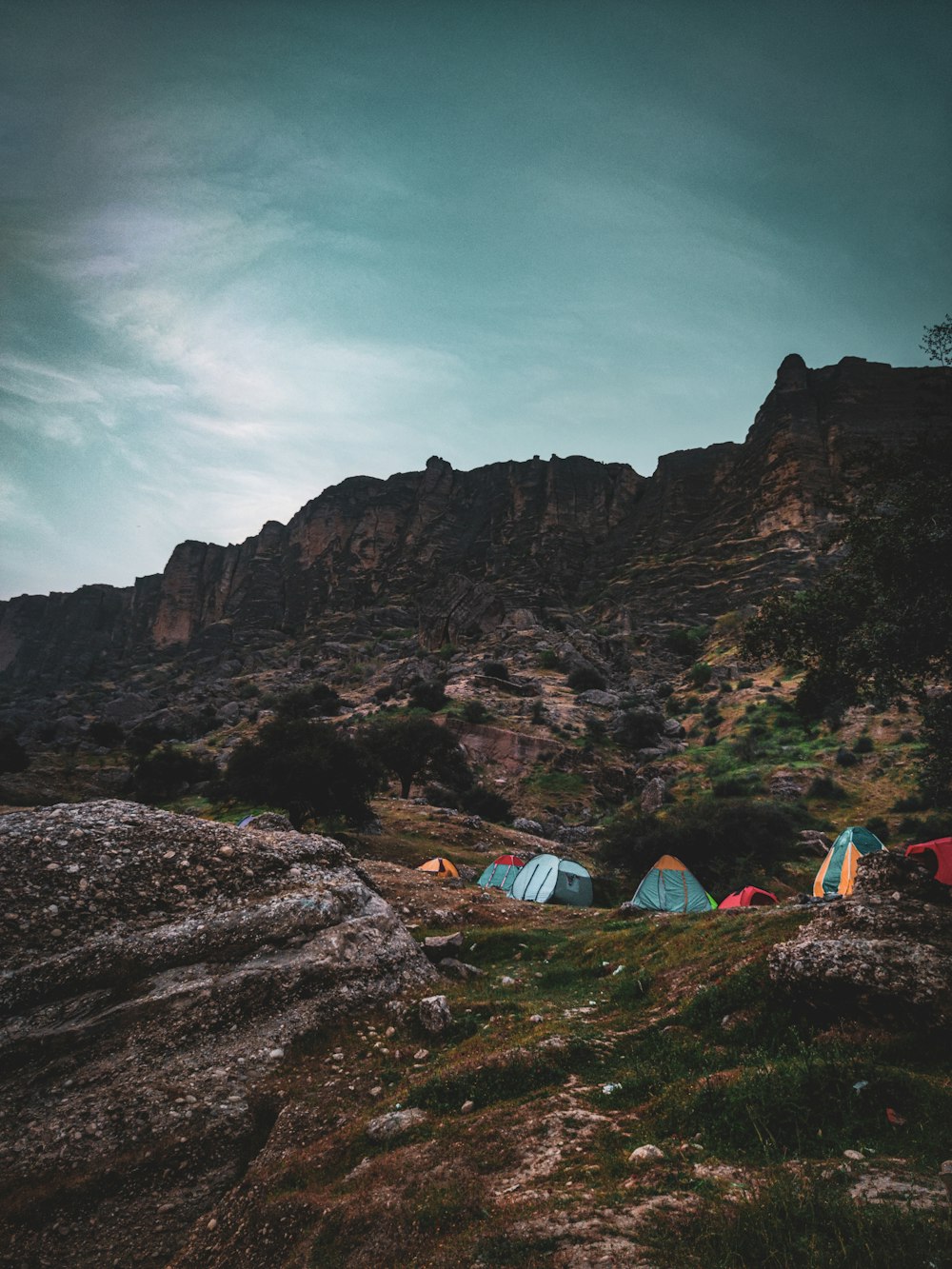 a group of tents sitting on top of a lush green hillside