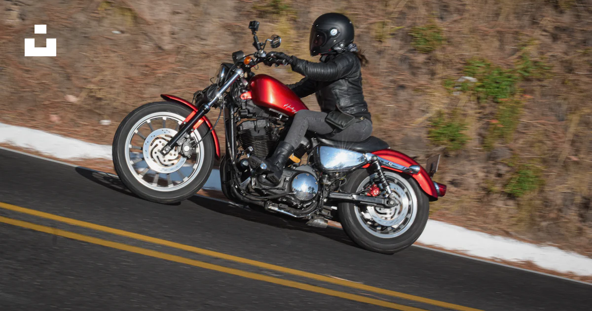 A man riding a red motorcycle down a curvy road photo – Free Ride a ...