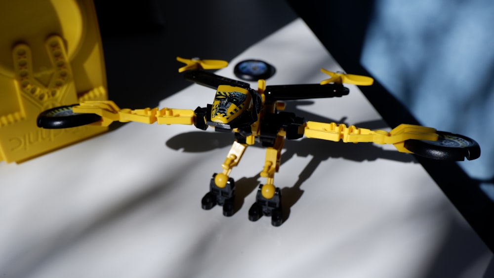 a yellow and black toy airplane on a table