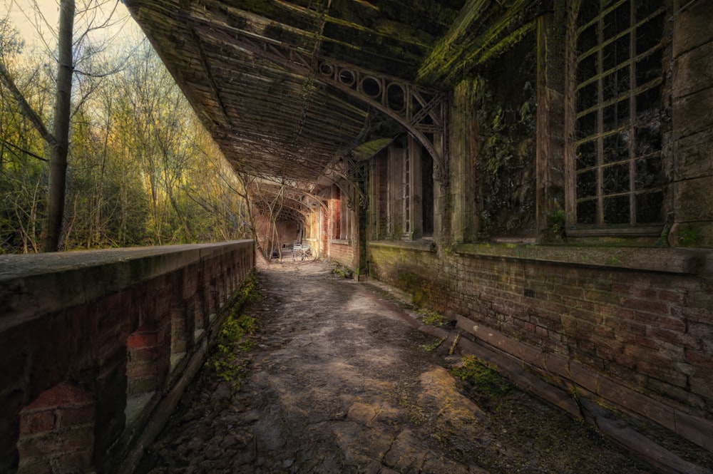 an old abandoned building with a walkway going through it