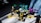 Four colorful toy robot figures arranged on a white surface, each in different postures with bright lighting casting shadows on some parts. The toys are primarily composed of pieces in bright yellow, turquoise, purple, and beige.