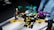 Four colorful toy robot figures arranged on a white surface, each in different postures with bright lighting casting shadows on some parts. The toys are primarily composed of pieces in bright yellow, turquoise, purple, and beige.